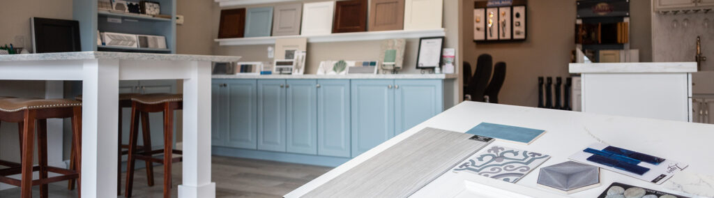 Interior design showroom displaying cabinet samples, tile swatches, and finish materials for home renovation planning