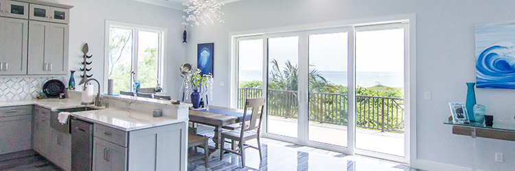 Luxury coastal kitchen with high-gloss tile flooring, marble countertops, and panoramic ocean views
