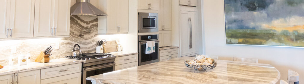 Luxury kitchen remodel in Stuart, FL featuring marble countertops, custom cabinetry, and stainless steel appliances by Masterpiece Builders