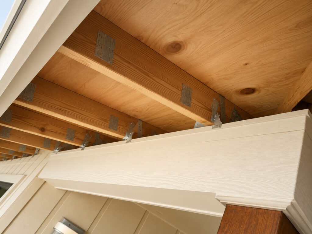 Hurricane strapping and galvanized metal connectors tying roof framing to the walls during a Masterpiece Design/Build renovation in Stuart, FL