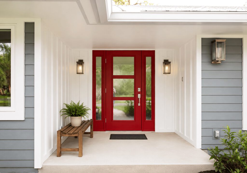 Home entry after a Masterpiece Design/Build renovation on the Treasure Coast with a red front door and new white and gray siding